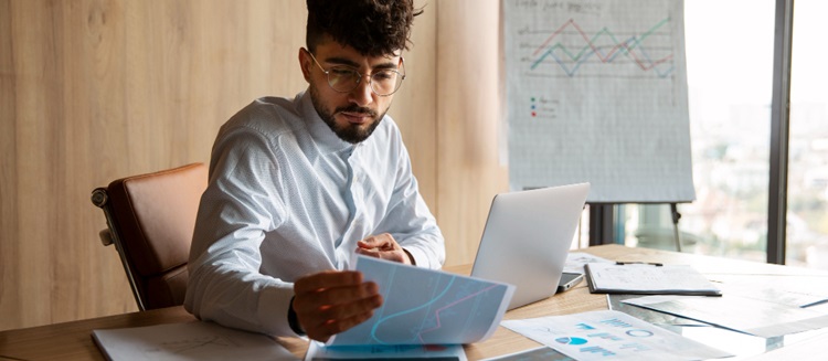 un homme regardant des chiffres sur son bureau